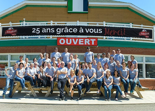 Group of employees in front of business